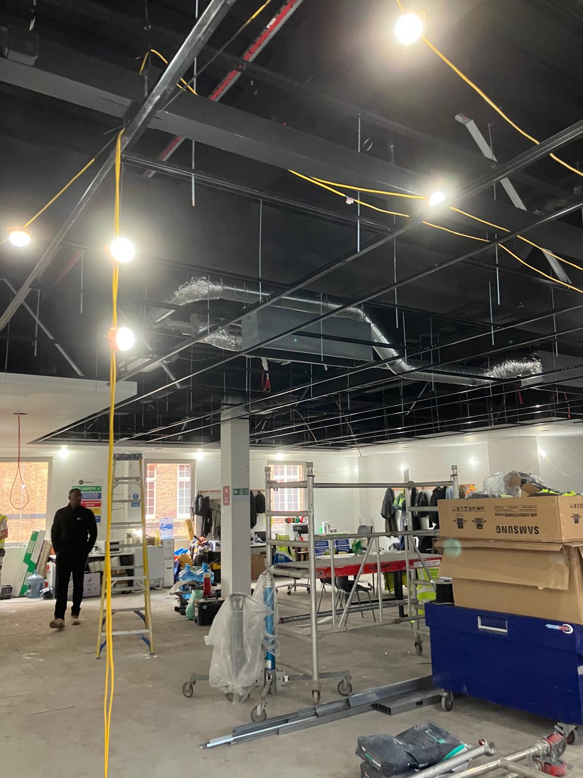 Open plan with ceiling grid and temporary lighting